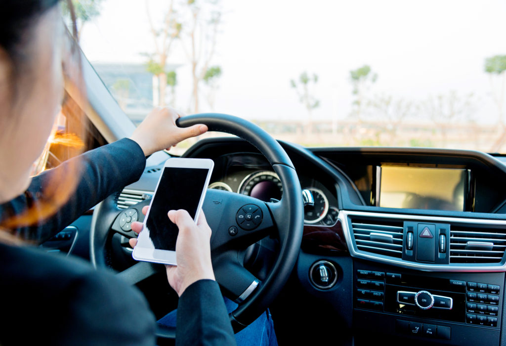 businesswoman texting while driving