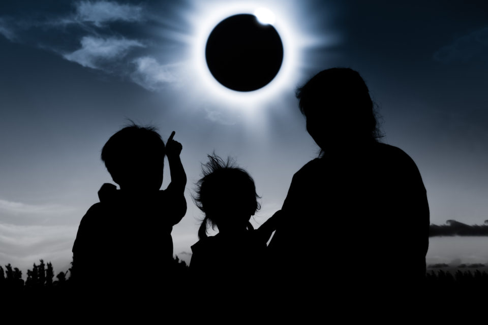Natural phenomenon. Silhouette of family sitting and relaxing together. Natural phenomenon. Silhouette of family sitting and relaxing together.